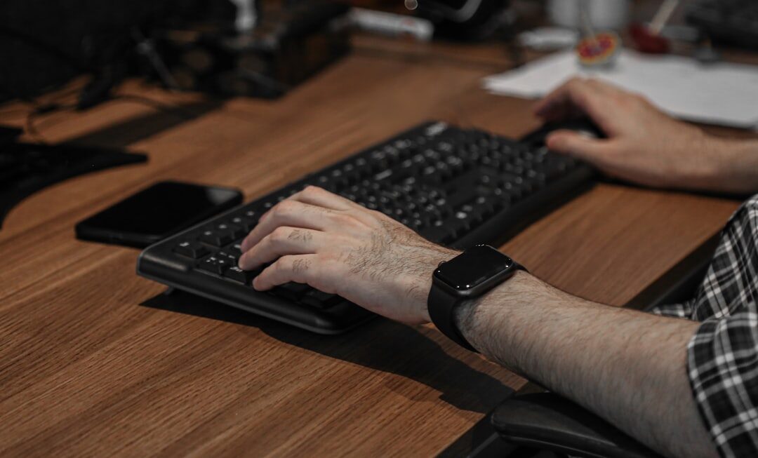 Software developer coding on multiple screens